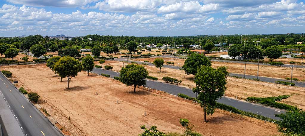Aerial view of Renaissance Marigold Meadows showing laid-out villa plots, formed roads and avenue trees